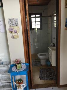 a small bathroom with a toilet and a sink at Refúgio dos Sonhos - Casa nas Montanhas - Monte Verde in Monte Verde +31 photos