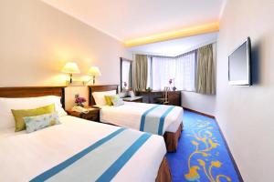 A bed or beds in a room at The Kimberley Hotel
