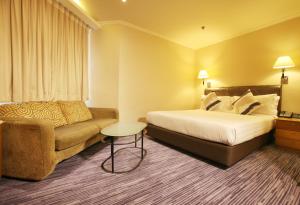 A bed or beds in a room at The Kimberley Hotel