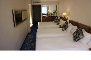 A bed or beds in a room at The Kimberley Hotel