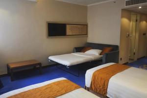 A bed or beds in a room at The Kimberley Hotel