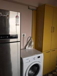 a kitchen with a washing machine next to a refrigerator at Ocean View Luxury Designer condo in Mumbai