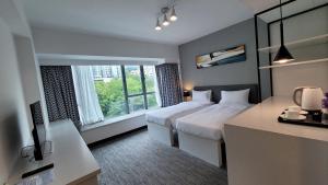 A bed or beds in a room at Grand Bay View Hotel