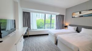 A bed or beds in a room at Grand Bay View Hotel