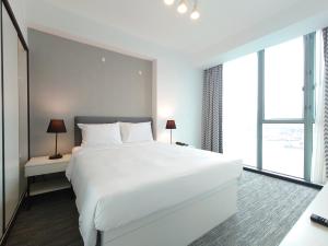 A bed or beds in a room at Grand Bay View Hotel