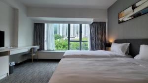 A bed or beds in a room at Grand Bay View Hotel