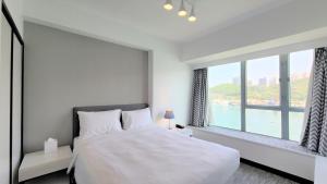 A bed or beds in a room at Grand Bay View Hotel