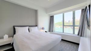 A bed or beds in a room at Grand Bay View Hotel