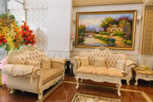 胡志明市的住宿－Thinh Gia Phat Hotel Hoang Hoa Tham，客厅配有两张沙发和一幅画