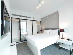 A bed or beds in a room at Grand Bay View Hotel