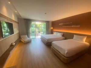 Ein Bett oder Betten in einem Zimmer der Unterkunft Baan Karon Resort