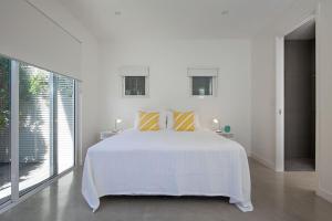 Postel nebo postele na pokoji v ubytování White Sands Beach House