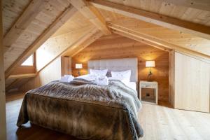 a bedroom with a large bed in a attic at Chasa Sömmi in Ftan