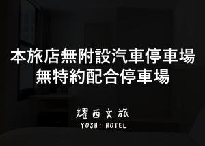 a sign with chinese writing on a wall at Yoshi Hotel in Tainan