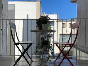 two chairs and a table on a balcony at Only in Bari in Bari