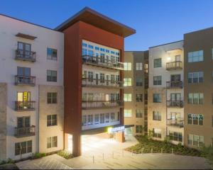 a view of an apartment building at night at Luxurious, 1 bedroom near Downtown & Dickies Arena in Fort Worth