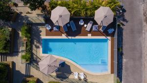 an overhead view of a swimming pool with umbrellas at Boom 6 Boomerang Beach in Boomerang Beach
