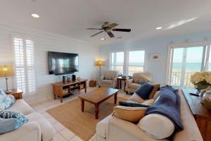 a living room with a couch and a tv at System Shutdown in Kure Beach