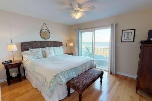 a bedroom with a bed with a view of the ocean at System Shutdown in Kure Beach