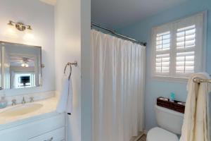 a bathroom with a tub and a sink and a toilet at System Shutdown in Kure Beach +42 photos