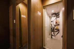 a hallway with a door leading into a room at HOTEL Cargo Shinsaibashi in Osaka