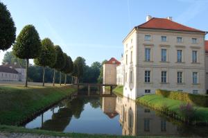 a building next to a river with a bridge at Ferienwohnung Rheinsberg Altstadt in Rheinsberg