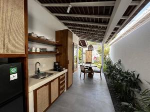 a kitchen with a sink and a table at Deluxe 1 Sula villa in uluwatu in Uluwatu