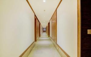 a corridor of a building with white walls and a long hallway at Collection O 78675 Collection O Key Rooms in New Delhi