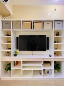 a white entertainment center with a tv in a room at * * L Iloilo's Quirky Oasis in Iloilo City