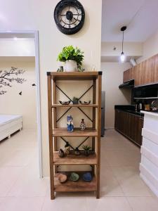 a shelf in a kitchen with a clock on the wall at * * L Iloilo's Quirky Oasis in Iloilo City
