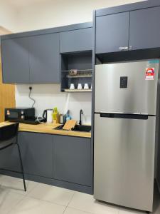 a kitchen with a stainless steel refrigerator at Meritus Service Apartment in Perai