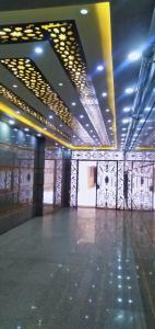 a large empty room with lights on the ceilings at A private room, the finest places with all services in Mājid Abū Zayd