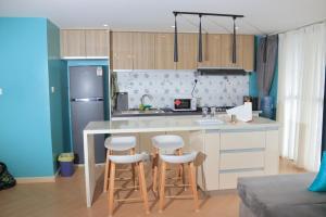 a kitchen with a counter and stools in a room at CitiHeart Suite in Nairobi