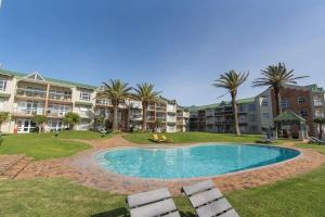 a swimming pool in the middle of a resort at 157 Brookes Hill Suites Near The Beach in Port Elizabeth
