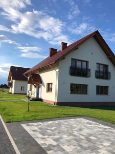 a white house with a red roof at Dobranocka Noclegi - blisko Energylandia in Spytkowice