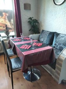 a dining room table with a red table cloth on it at le jack in Mont-sous-Vaudrey