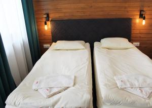 two beds sitting next to each other in a room at PM Services Borovets Garden Apartments in Borovets
