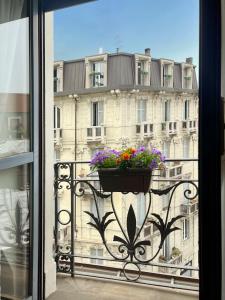 a balcony with a pot of flowers on a building at Easy Isola, for an easy stay in Milan
