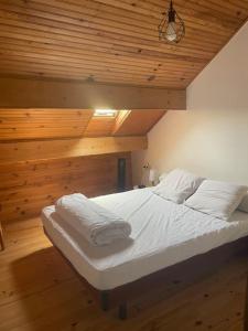 a bed with white sheets and pillows in a room at Chez Malo in Meschers-sur-Gironde