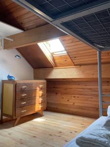 a bedroom with a bed and a dresser in it at Chez Malo in Meschers-sur-Gironde