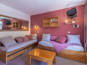 a room with two beds and a tv on a wall at Appartement Valmorel, 2 pièces, 4 personnes - FR-1-356-301 in Valmorel