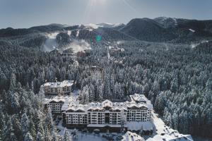 an aerial view of a resort with snow covered trees at PM Services Borovets Garden Apartments in Borovets