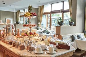 a buffet with fruits and desserts on a table at Hotel Deimann in Schmallenberg