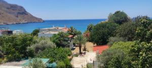 a view of a village and the ocean at Alkyonis Apartments in Panormos Kalymnos