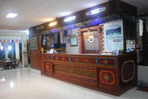a restaurant with a large wooden counter in a building at Hotel Sorga Cottages in Kuta +46 photos