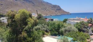 a view of a town and the ocean at Alkyonis Apartments in Panormos Kalymnos