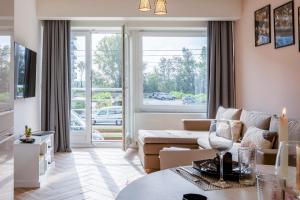 a living room with a couch and a table at EVA-Modern 2 bedroom apartment seaside Oostende in Ostend