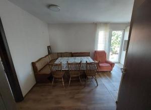 a dining room with a table and chairs and a couch at Seosko domacinstvo Nedic in Valjevo