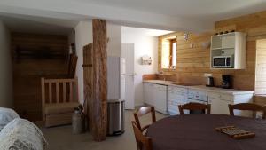a kitchen with a table and a kitchen with a counter at Maison de village au cœur du hameau Les Marches à Orcières in Orcières