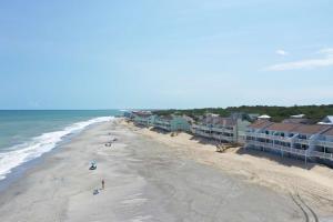 an aerial view of a beach with houses and the ocean at Sand Castle in Kure Beach
